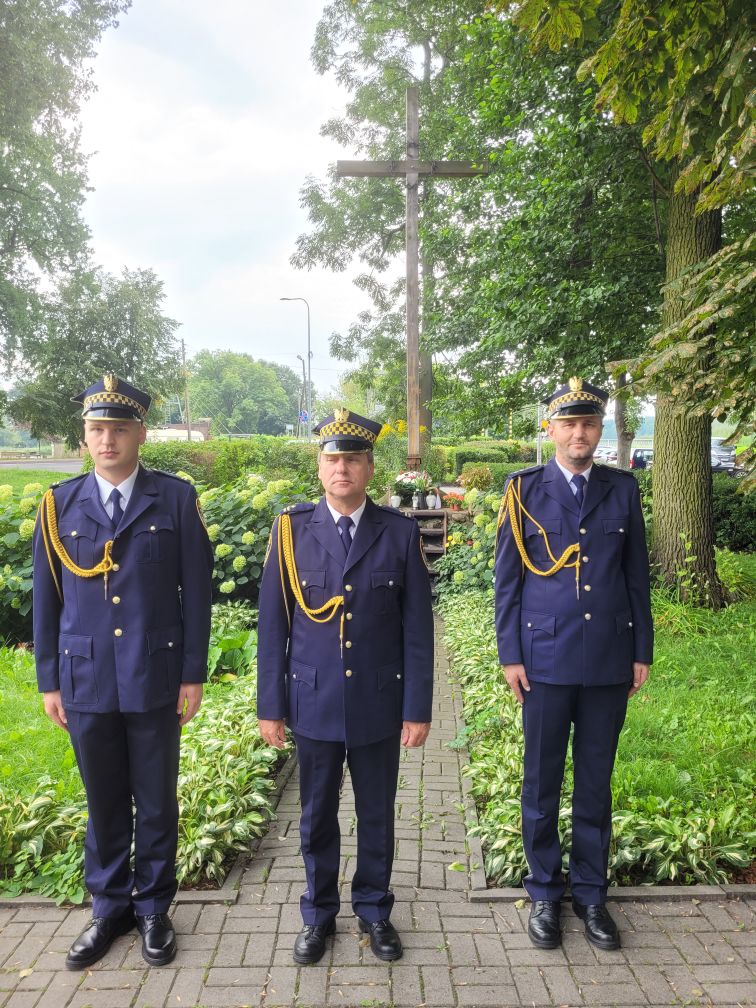 Trzech strażników miejskich ubranych w mundur służbowy. 