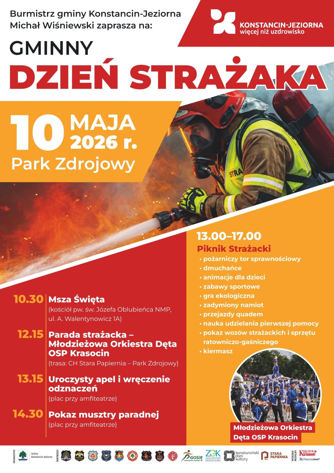Plakat informujący o Gminnym Dniu Strażaka w Konstancinie-Jeziornie (10 maja 2026 r., Park Zdrojowy) z programem wydarzeń oraz zdjęciem strażaka gaszącego pożar.