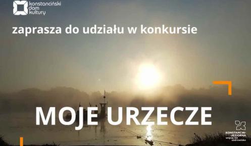 na pierwszym planie biały napis MOJE URZECZE, powyżej logo konstancińskiego domu kultury oraz napis zaprasza do udziału w konkursie. W tle zachód słońca nad rzeką.