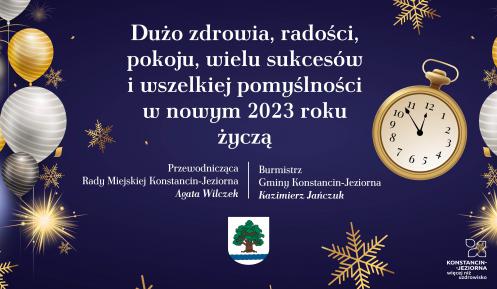 Grafika wektorowa. Na błękitnym tle białe i złote balony, gwiazdy i płatki śniegu. Na środku życzenia od władz gminy, ich treść podana jest w artykule. Poniżej życzeń herb gminy.