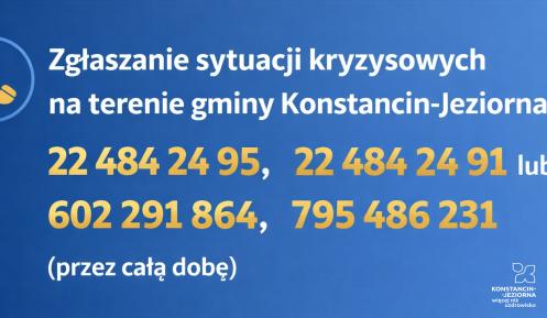 Pozioma grafika informacyjna na niebieskim tle z żółtym znakiem ostrzegawczym i numerami telefonów do całodobowego zgłaszania sytuacji kryzysowych na terenie gminy Konstancin-Jeziorna.