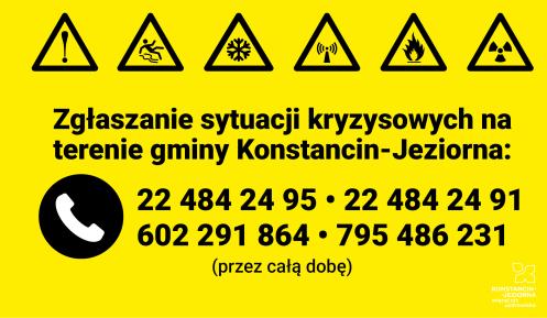 Żółta plansza informacyjna z ikonami zagrożeń i numerami telefonów do całodobowego zgłaszania sytuacji kryzysowych na terenie gminy Konstancin-Jeziorna.