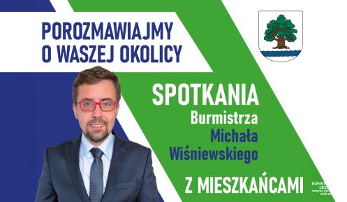 Grafika promująca spotkania burmistrza Michała Wiśniewskiego z mieszkańcami, zawierająca jego zdjęcie, herb gminy oraz hasło „Porozmawiajmy o waszej okolicy”.