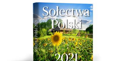 Książka - album. Na jego okładce jest zdjęcie pola słoneczników. Nad nimi niebieskie niebo. Na nim znajduje się biały napis Sołectwa Polski 2021. 