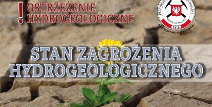 Grafika wektorowa informująca o wprowadzeniu stanu zagrożenia hydrogeologicznego. Napis na tle wyschniętej gleby.