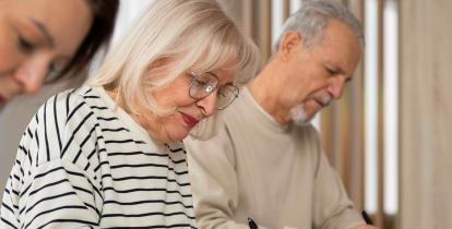 Seniorzy siedzą przy stole