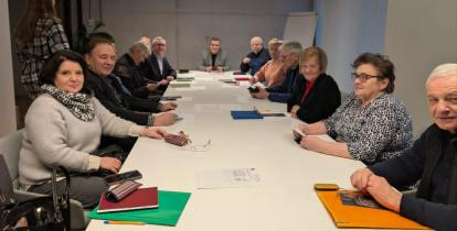 Grupa osób siedzi przy stole