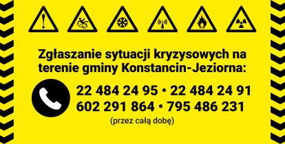 Żółta plansza informacyjna z ikonami zagrożeń i numerami telefonów do całodobowego zgłaszania sytuacji kryzysowych na terenie gminy Konstancin-Jeziorna.