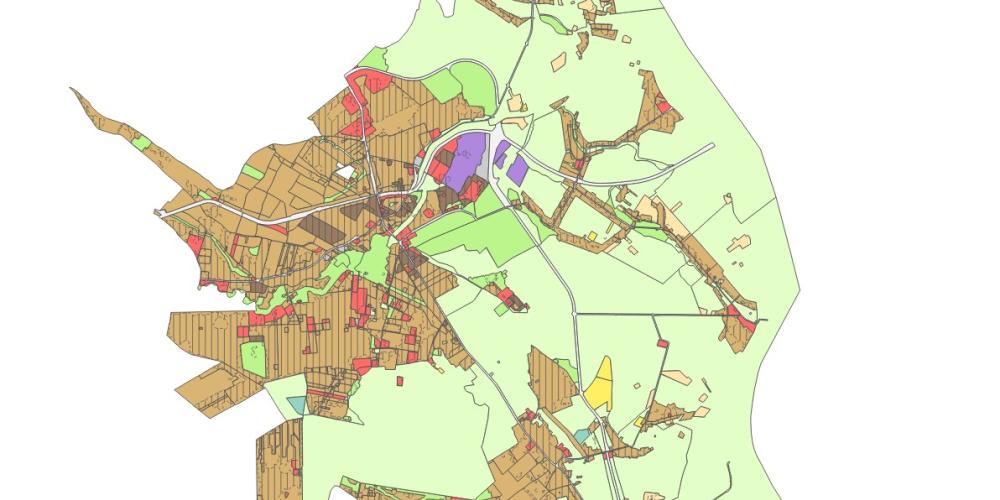 Mapa planistyczna gminy przedstawiająca zróżnicowane przeznaczenie terenów w formie kolorowych stref, z dominującą zabudową w części centralnej oraz rozległymi obszarami zielonymi na obrzeżach.