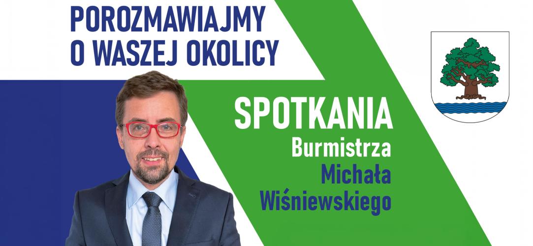 Grafika promująca spotkania burmistrza Michała Wiśniewskiego z mieszkańcami, zawierająca jego zdjęcie, herb gminy oraz hasło „Porozmawiajmy o waszej okolicy”.