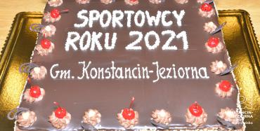 Tort czekoladowy w kształcie prostokąta, na środku napis: Sportowcy roku 2021 gm. Konstancin-Jeziorna.