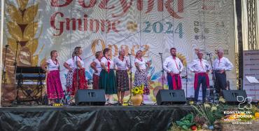 na scenie kobiety i mężczyźni w kolorowych strojach
