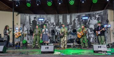 Harcerski zespół muzyczny wykonuje koncert na scenie amfiteatru.