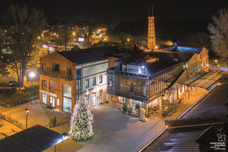 Aerial view of post-factory buildings in winter scenery, lighting and Christmas decorations 