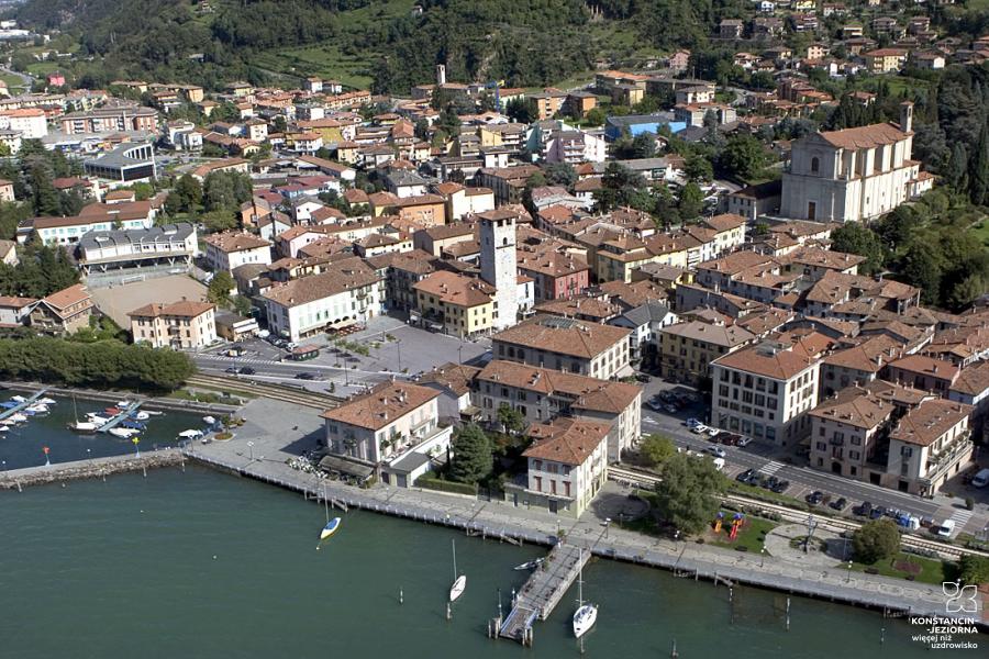Aerial view of the quay of the historic city with old buildings, visible stone buildings and a tower 