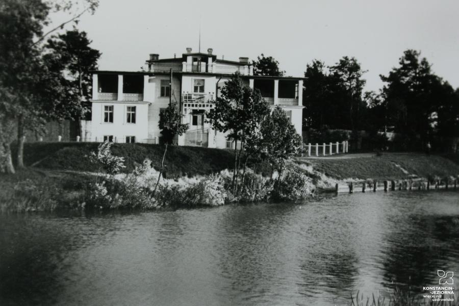 old black and white photos showing a two-story building situated under the water 