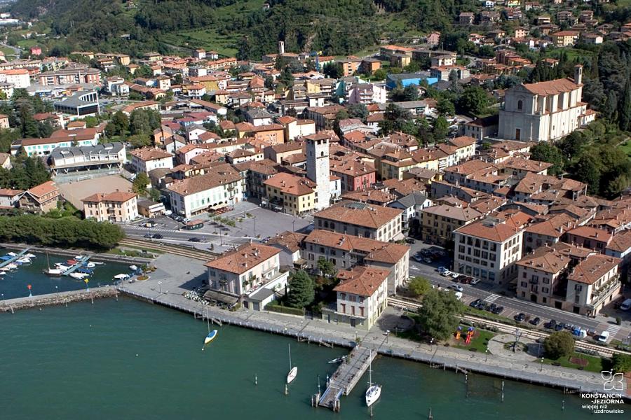 Aerial view of the quay of the historic city with old buildings, visible stone buildings and a tower 