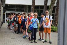 Grupa uczniów stojąca przed budynkiem Gminnego Ośrodka Sportu i Rekreacji