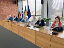 Grupa osób siedzi przy stole.
