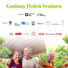 Grupa osób siedzi przy stole.
