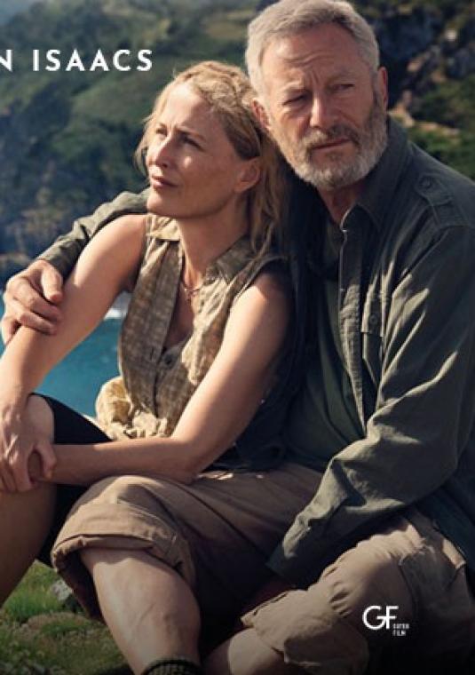 Kadr z filmu przedstawiający parę bohaterów graną przez Gillian Anderson i Jasona Isaacsa. Siedzą wtuleni w siebie na trawiastym klifie, patrząc w stronę oceanu. Oboje są ubrani w stroje turystyczne. Na grafice widnieje duży biały tytuł „ŚCIEŻKI ŻYCIA” oraz hasło: „Stracili wszystko, zyskali siebie”. W górnej części nazwiska głównych aktorów.